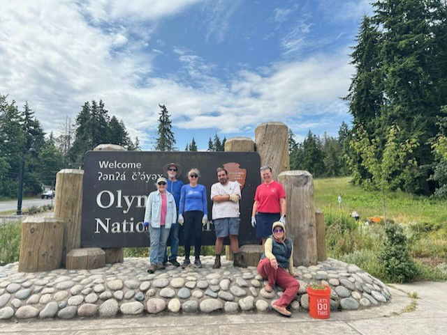Volunteers weeding the entrance sign garden at Olympic National Park