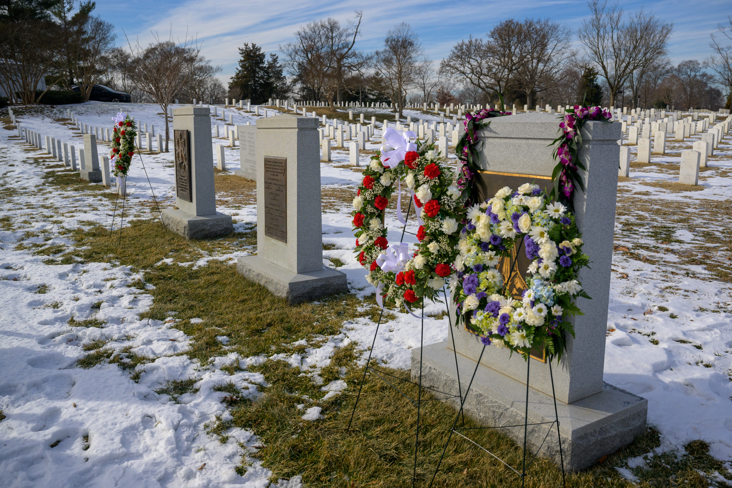 Wreaths of flowers stand at the Space Shuttle Columbia Memorial in a snowy Arlington National Cemetery during NASA's Day of Remembrance
